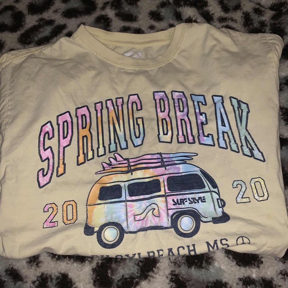 medium sized yellow t shirt with graphics on the front